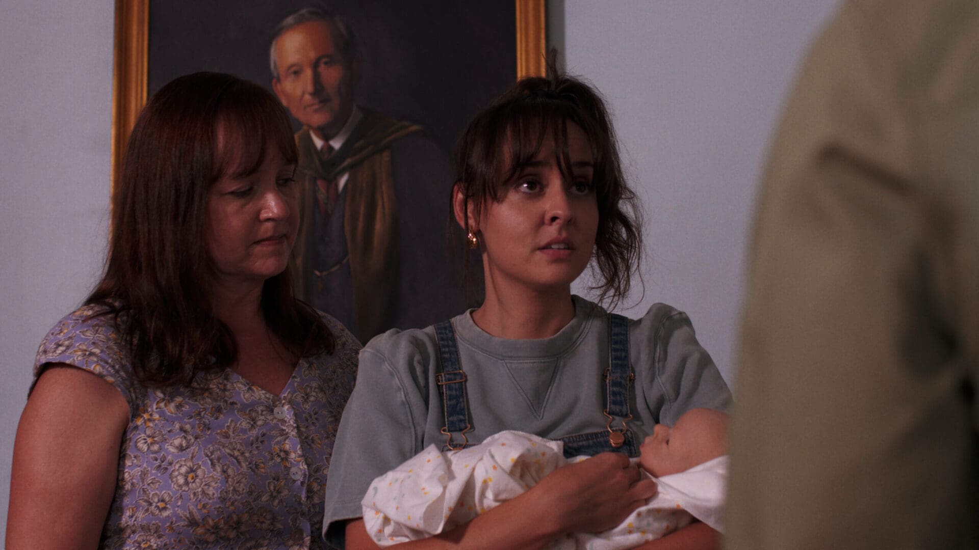 A woman holding a baby in her arms. A woman holding a baby in her arms.