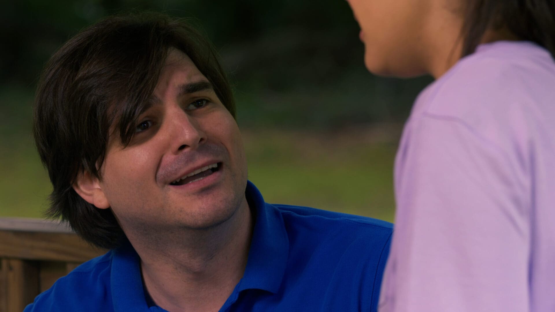 A man talking to another person in front of him. A man talking to another person in front of him.